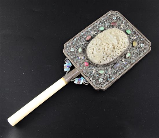 A Chinese silver and gem stone mount hand mirror with 17th/18th century jade plaque, the mount early 20th century, total length 27cm